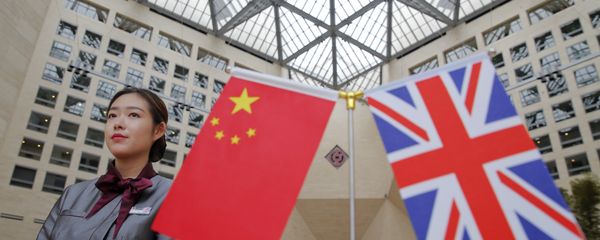 A member of staff stands behind flags as officials arrive for the UK-China High Level Financial Services Roundtable at the Bank of China head office building in Beijing on July 22, 2016 A member of staff stands behind flags as officials arrive for the UK-China High Level Financial Services Roundtable at the Bank of China head office building in Beijing on July 22, 2016 - Sputnik International