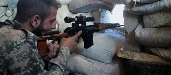 A Syrian Army soldier at the front line against a military logistics school in southern Aleppo A Syrian Army soldier at the front line against a military logistics school in southern Aleppo - Sputnik International