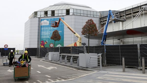 Construction workers wheel equipment as they work at the departures hall at Zaventem Airport in Brussels on Friday. - Sputnik International