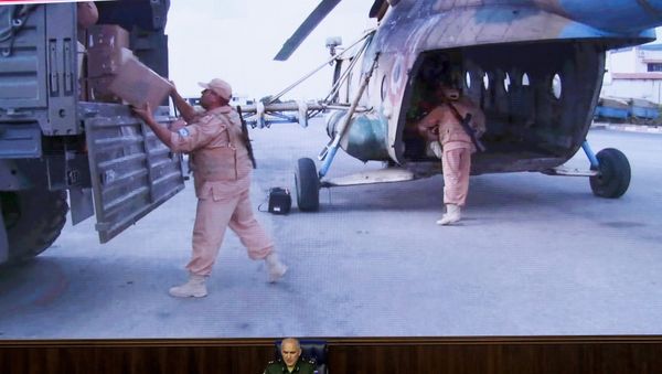 Lt.-Gen. Sergei Rudskoi of the Russian Military General Staff, speaks to the media as Syrian army soldiers load a humanitarian aid at Aleppo is displayed on screen at a Russian Defense Ministry building in Moscow, Russia, Monday, Aug. 1, 2016 - Sputnik International