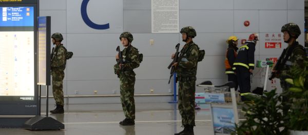 Paramilitary police officers stand guard inside Pudong airport in Shanghai (File) Paramilitary police officers stand guard inside Pudong airport in Shanghai (File) - Sputnik International