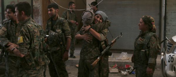 Syria Democratic Forces (SDF) female fighters embrace each other in the city of Manbij, in Aleppo Governorate, Syria, August 10, 2016 - Sputnik International