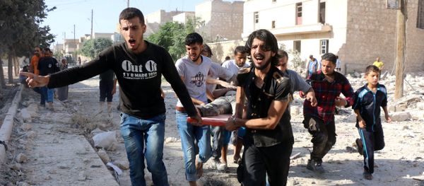 Syrians carry a stretcher as they evacuate victims from the rubble of a collapsed building following a reported air strike on the rebel-held neighbourhood of Sakhur in the northern city of Aleppo on July 19, 2016 Syrians carry a stretcher as they evacuate victims from the rubble of a collapsed building following a reported air strike on the rebel-held neighbourhood of Sakhur in the northern city of Aleppo on July 19, 2016 - Sputnik International