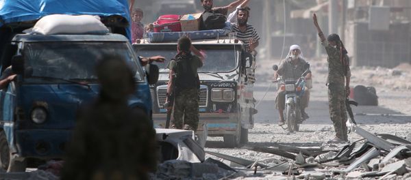 Syria Democratic Forces (SDF) fighters greet civilians who were evacuated by the SDF from an Islamic State-controlled neighbourhood of Manbij, in Aleppo Governorate, Syria, August 12, 2016 - Sputnik International