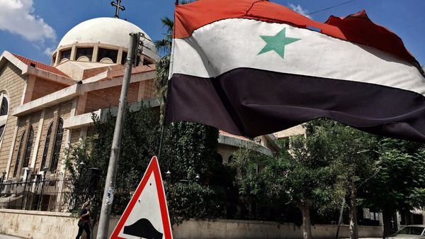 A state flag of the Syrian Arab Republic by an Orthodox church in an old Christian block of Aleppo, Syria A state flag of the Syrian Arab Republic by an Orthodox church in an old Christian block of Aleppo, Syria - Sputnik International