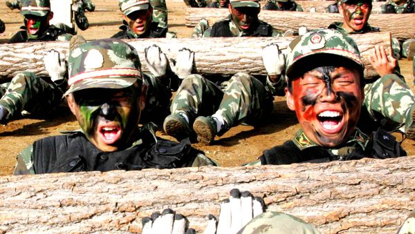 In this photo released by China's Xinhua News Agency, fresh men of the special police train the strength of their muscles during a one-week drilling in Beijing. file photo - Sputnik International