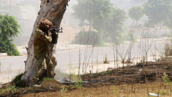 A member of forces loyal to Libya's UN-backed Government of National Accord (GNA), aims his weapon in al-Zaafaran neighbourhood as pro-government forces fight with Islamic State group (IS) fighters holed up in residential district two on August 14, 2016 in Sirte, east of the capital Tripoli - Sputnik International