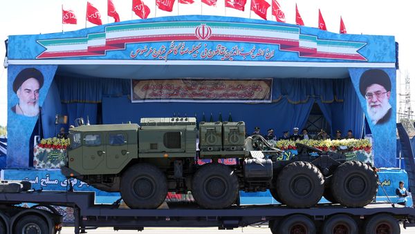 In front of the portraits of supreme leader Ayatollah Ali Khamenei, right, and late revolutionary founder Ayatollah Khomeini, left, a long-range, S-300 missile system is displayed by Iran's army during a parade marking National Army Day at the mausoleum of the late revolutionary founder Ayatollah Khomeini, outside Tehran. file photo - Sputnik International