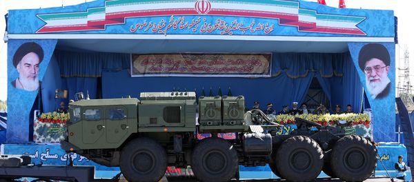 In front of the portraits of supreme leader Ayatollah Ali Khamenei, right, and late revolutionary founder Ayatollah Khomeini, left, a long-range, S-300 missile system is displayed by Iran's army during a parade marking National Army Day at the mausoleum of the late revolutionary founder Ayatollah Khomeini, outside Tehran. file photo - Sputnik International