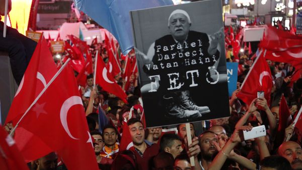 Supporters of Turkish President Recep Tayyip Erdogan wave their national flags and hold a portrait of Fethullah Gulen, a U.S.-based Muslim cleric with Turkish words that read: the Coup nation traitor, FETO (Feto is the nickname of Fethullah Gulen), during a pro-government rally at Kizilay main square, in Ankara, Turkey, Wednesday, July 20, 2016 Supporters of Turkish President Recep Tayyip Erdogan wave their national flags and hold a portrait of Fethullah Gulen, a U.S.-based Muslim cleric with Turkish words that read: the Coup nation traitor, FETO (Feto is the nickname of Fethullah Gulen), during a pro-government rally at Kizilay main square, in Ankara, Turkey, Wednesday, July 20, 2016 - Sputnik International
