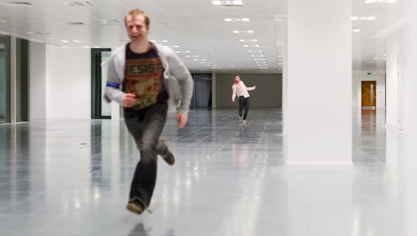 A zombie actor chases a man during a zombie game A zombie actor chases a man during a zombie game - Sputnik International
