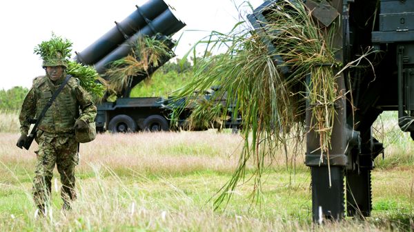 A soldier from Japan's Ground Self-Defense Force helps to prepare surface-to-ship missile launchers at Camp Naha in Naha, Okinawa Prefecture (File) - Sputnik International