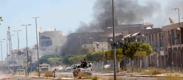 Fighters ride a pickup truck as smoke rises during a battle with Islamic State fighters in neighborhood Number Two in Sirte, Libya Fighters ride a pickup truck as smoke rises during a battle with Islamic State fighters in neighborhood Number Two in Sirte, Libya - Sputnik International