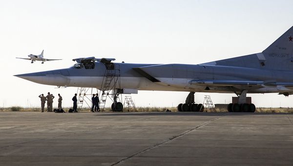 In this photo taken on Monday, Aug. 15, 2016, a Russian Tu-22M3 bomber stands on the tarmac while another plane lands at an air base near Hamedan, Iran. - Sputnik International