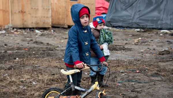 Migrant children play in the southern part of the so-called 'Jungle' migrant camp in Calais, northern France Migrant children play in the southern part of the so-called 'Jungle' migrant camp in Calais, northern France - Sputnik International