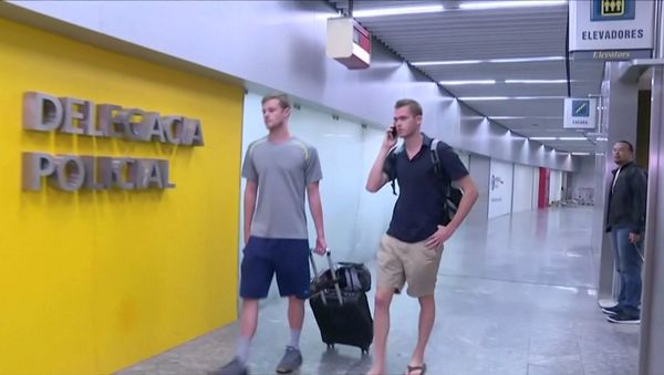 U.S. Olympic swimmers Gunnar Bentz and Jack Conger walk to the airport police station office at Rio's international airport in this still frame taken from video dated August 17, 2016, in Rio De Janeiro, Brazil. U.S. Olympic swimmers Gunnar Bentz and Jack Conger walk to the airport police station office at Rio's international airport in this still frame taken from video dated August 17, 2016, in Rio De Janeiro, Brazil. - Sputnik International