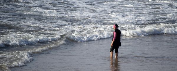 A Moroccan woman wearing a burkini, a full-body swimsuit designed for Muslim women, enters the sea at Oued Charrat beach, near the capital Rabat A Moroccan woman wearing a burkini, a full-body swimsuit designed for Muslim women, enters the sea at Oued Charrat beach, near the capital Rabat - Sputnik International