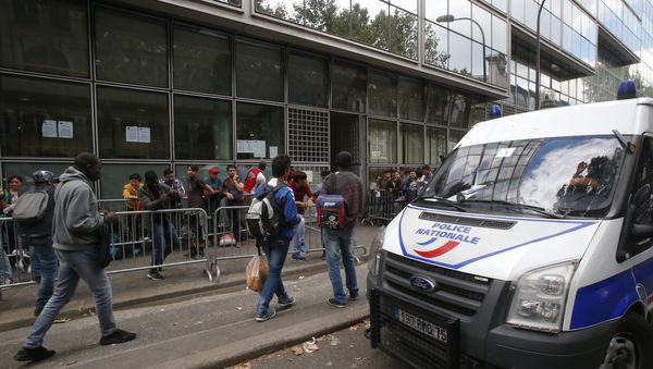 A police van parks as refugees queue outside a refugees center in Paris A police van parks as refugees queue outside a refugees center in Paris - Sputnik International