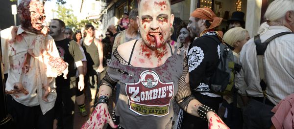 Zombies walk down Fifth Avenue as they take part in the Zombie Walk on day three of the Comic-Con International held at the San Diego Convention Center Zombies walk down Fifth Avenue as they take part in the Zombie Walk on day three of the Comic-Con International held at the San Diego Convention Center - Sputnik International