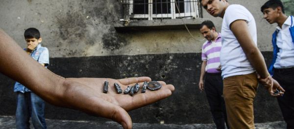 A person shows pieces of projectile near the explosion scene following a late night attack on a wedding party that left at least 30 dead in Gaziantep in southeastern Turkey near the Syrian border on August 21, 2016 A person shows pieces of projectile near the explosion scene following a late night attack on a wedding party that left at least 30 dead in Gaziantep in southeastern Turkey near the Syrian border on August 21, 2016 - Sputnik International