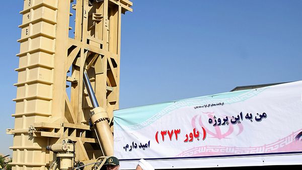 Iran's President Hassan Rouhani (R) and Defence Minister Hossein Dehghan stand in front of the new air defense missile system Bavar-373, in Tehran, Iran August 21, 2016 - Sputnik International