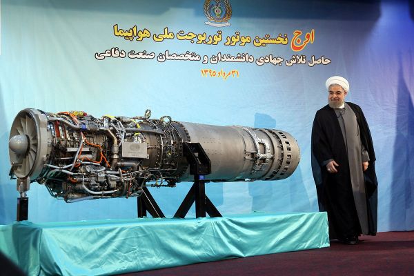 Iran's President Hassan Rouhani stands next to an Iranian-made fighter jet engine, in Tehran, Iran August 21, 2016 - Sputnik International