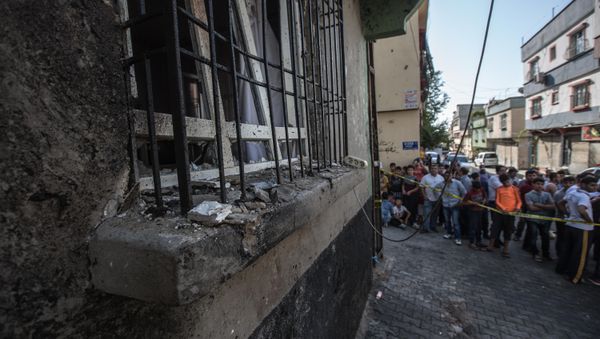 People stand near the explosion scene following a late night attack on a wedding party that left at least 30 dead in Gaziantep in southeastern Turkey near the Syrian border on August 21, 2016 People stand near the explosion scene following a late night attack on a wedding party that left at least 30 dead in Gaziantep in southeastern Turkey near the Syrian border on August 21, 2016 - Sputnik International
