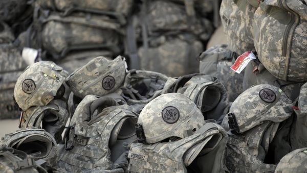 Helmets and body armor are are stacked and ready to go outside the passenger terminal at Sather Air Base in Baghdad, Iraq, for U.S. Army soldiers from the 3rd Armored Cavalry Regiment to begin their journey home to the United States after a yearlong deployment (File) - Sputnik International