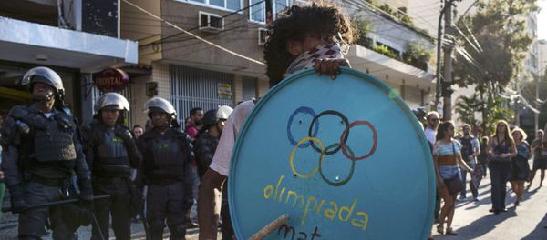 016 Rio Olympics - Opening Ceremony - Maracana - Rio de Janeiro, Brazil - 05/08/2016. Protester stands in front of riot police during demonstration against the Olympic Games near the Maracana stadium - Sputnik International