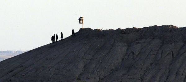 In this file photo Daesh terrorists are seen after placing their group's flag on a hilltop at the eastern side of the town of Kobani, Syria In this file photo Daesh terrorists are seen after placing their group's flag on a hilltop at the eastern side of the town of Kobani, Syria - Sputnik International