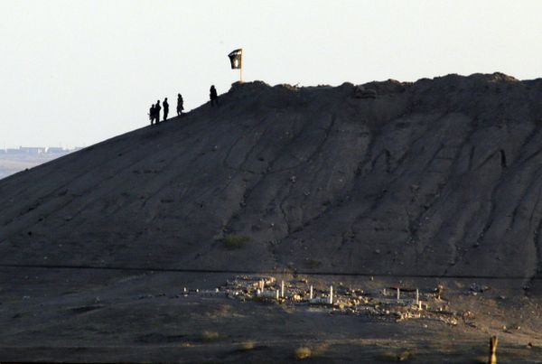 In this file photo Daesh terrorists are seen after placing their group's flag on a hilltop at the eastern side of the town of Kobani, Syria In this file photo Daesh terrorists are seen after placing their group's flag on a hilltop at the eastern side of the town of Kobani, Syria - Sputnik International