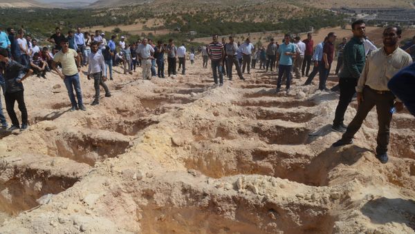 People wait close to empty graves at a cemetery during the funeral for the victims of last night's attack on a wedding party that left 50 dead in Gaziantep in southeastern Turkey near the Syrian border on August 21, 2016 People wait close to empty graves at a cemetery during the funeral for the victims of last night's attack on a wedding party that left 50 dead in Gaziantep in southeastern Turkey near the Syrian border on August 21, 2016 - Sputnik International