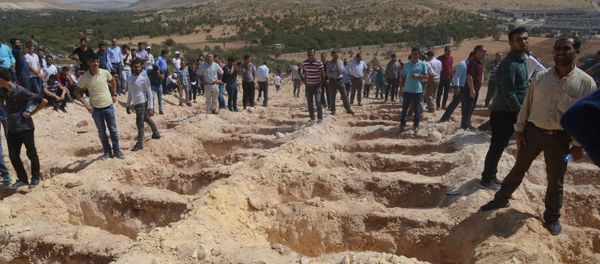 People wait close to empty graves at a cemetery during the funeral for the victims of last night's attack on a wedding party that left 50 dead in Gaziantep in southeastern Turkey near the Syrian border on August 21, 2016 People wait close to empty graves at a cemetery during the funeral for the victims of last night's attack on a wedding party that left 50 dead in Gaziantep in southeastern Turkey near the Syrian border on August 21, 2016 - Sputnik International