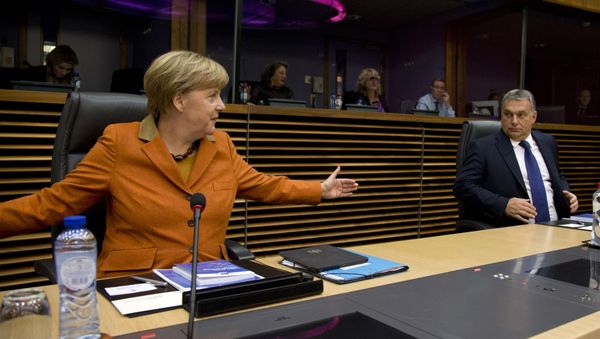 German Chancellor Angela Merkel, left, gestures regarding the space between chairs as she speaks with Hungarian Prime Minister Viktor Orban prior to the start of a round table meeting during an EU summit at EU headquarters in Brussels on Sunday, Oct. 25, 2015. - Sputnik International