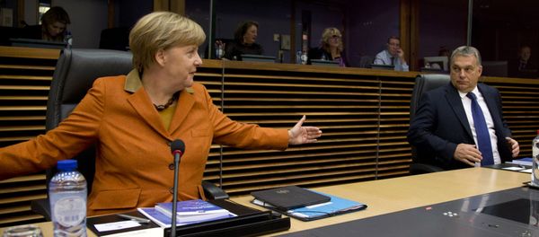 German Chancellor Angela Merkel, left, gestures regarding the space between chairs as she speaks with Hungarian Prime Minister Viktor Orban prior to the start of a round table meeting during an EU summit at EU headquarters in Brussels on Sunday, Oct. 25, 2015. - Sputnik International