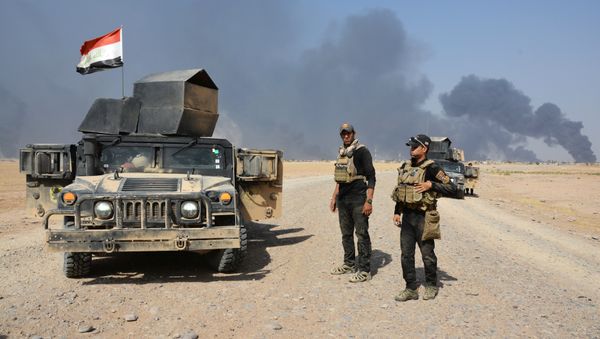 Iraqi security forces gather on the outskirt of Al Qayyarah, Iraq, August 15, 2016. Picture taken August 15, 2016 Iraqi security forces gather on the outskirt of Al Qayyarah, Iraq, August 15, 2016. Picture taken August 15, 2016 - Sputnik International