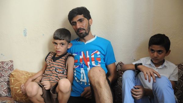 Ahmet Abdullah, whose daughter Fatma was killed in the suicide bombing attack in Gaziantep, with his two sons. Ahmet Abdullah, whose daughter Fatma was killed in the suicide bombing attack in Gaziantep, with his two sons. - Sputnik International