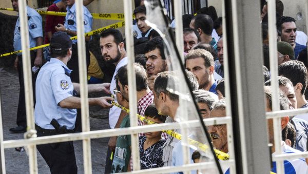People stand near the explosion scene behind police cordon following a late night attack on a wedding party that left at least 30 dead in Gaziantep in southeastern Turkey near the Syrian border on August 21, 2016 People stand near the explosion scene behind police cordon following a late night attack on a wedding party that left at least 30 dead in Gaziantep in southeastern Turkey near the Syrian border on August 21, 2016 - Sputnik International