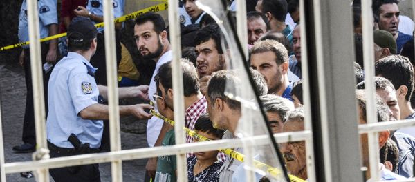 People stand near the explosion scene behind police cordon following a late night attack on a wedding party that left at least 30 dead in Gaziantep in southeastern Turkey near the Syrian border on August 21, 2016 People stand near the explosion scene behind police cordon following a late night attack on a wedding party that left at least 30 dead in Gaziantep in southeastern Turkey near the Syrian border on August 21, 2016 - Sputnik International