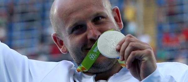 Piotr Malachowski (POL) of Poland poses with his silver medal. Piotr Malachowski (POL) of Poland poses with his silver medal. - Sputnik International