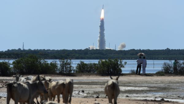 Bystanders watch as Indian Space Research Organisation's (ISRO) satellite CARTOSAT-2, along with 20 other satellites from the US, Canada, Germany and Indonesia on board the Polar Satellite Launch Vehicle (PSLV-C34), is launched from Sriharikota in the southern state of Andhra Pradesh on June 22, 2016 Bystanders watch as Indian Space Research Organisation's (ISRO) satellite CARTOSAT-2, along with 20 other satellites from the US, Canada, Germany and Indonesia on board the Polar Satellite Launch Vehicle (PSLV-C34), is launched from Sriharikota in the southern state of Andhra Pradesh on June 22, 2016 - Sputnik International