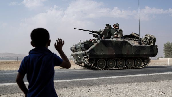 A child waves toward Turkish troops heading to the Syrian border, in Karkamis, Turkey, Friday, Aug. 26, 2016 A child waves toward Turkish troops heading to the Syrian border, in Karkamis, Turkey, Friday, Aug. 26, 2016 - Sputnik International