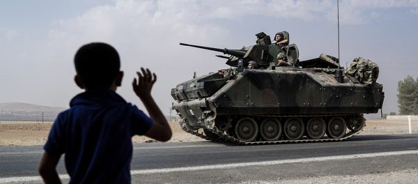 A child waves toward Turkish troops heading to the Syrian border, in Karkamis, Turkey, Friday, Aug. 26, 2016 A child waves toward Turkish troops heading to the Syrian border, in Karkamis, Turkey, Friday, Aug. 26, 2016 - Sputnik International