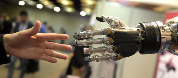 A man moves his hand toward SVH (Servo Electric 5 Finger Gripping Hand) automated hand made by Schunk during the 2014 IEEE-RAS International Conference on Humanoid Robots in Madrid on November 19, 2014 A man moves his hand toward SVH (Servo Electric 5 Finger Gripping Hand) automated hand made by Schunk during the 2014 IEEE-RAS International Conference on Humanoid Robots in Madrid on November 19, 2014 - Sputnik International