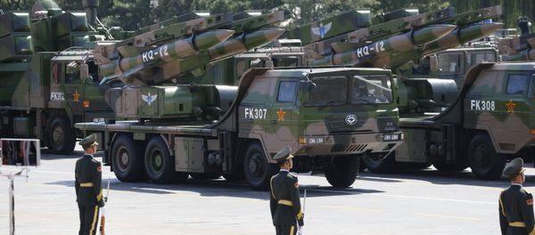 Military vehicles carry HQ-12 surface-to-air missile batteries during a parade commemorating the 70th anniversary of Japan's surrender during World War II. Military vehicles carry HQ-12 surface-to-air missile batteries during a parade commemorating the 70th anniversary of Japan's surrender during World War II. - Sputnik International