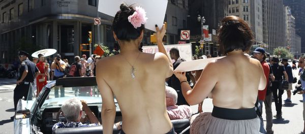 Participants ride in a convertible through midtown Manhattan in the Go Topless Pride Parade, Sunday, Aug. 28, 2016, in New York - Sputnik International