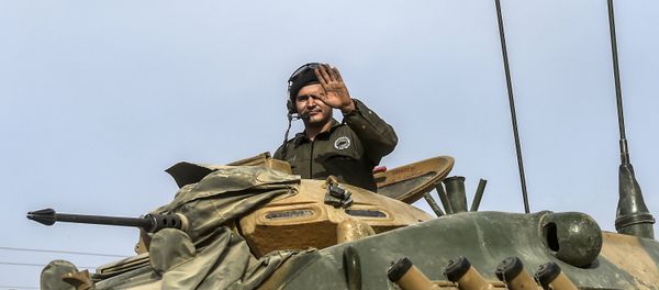 This picture taken around 5 kilometres west from the Turkish Syrian border city of Karkamis in the southern region of Gaziantep, on August 25, 2016 shows a soldier gesturing as Turkish Army tanks drive to the Syrian Turkish border town of Jarabulus This picture taken around 5 kilometres west from the Turkish Syrian border city of Karkamis in the southern region of Gaziantep, on August 25, 2016 shows a soldier gesturing as Turkish Army tanks drive to the Syrian Turkish border town of Jarabulus - Sputnik International