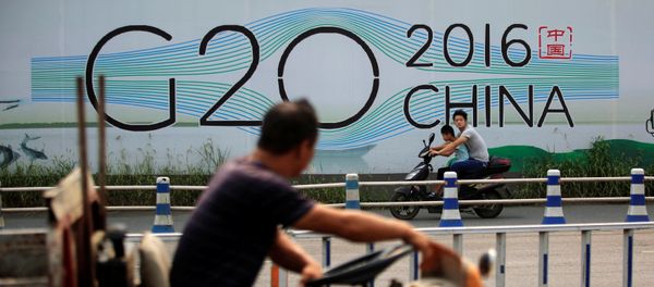People cycle past a billboard for the upcoming G20 summit in Hangzhou, Zhejiang province, China, July 29, 2016 - Sputnik International