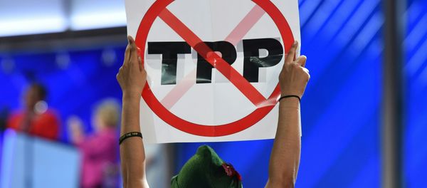 A delegate hoists and anti-TPP sign on Day 1 of the Democratic National Convention at the Wells Fargo Center in Philadelphia, Pennsylvania, July 25, 2016 A delegate hoists and anti-TPP sign on Day 1 of the Democratic National Convention at the Wells Fargo Center in Philadelphia, Pennsylvania, July 25, 2016 - Sputnik International