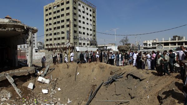 Yemenis gather around a crater caused by a Saudi-led airstrike that targeted a building in the centre of the capital Sanaa (File) Yemenis gather around a crater caused by a Saudi-led airstrike that targeted a building in the centre of the capital Sanaa (File) - Sputnik International